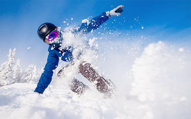 picture of a snowboarder in fresh snow